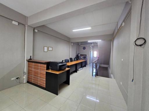 Spacious and modern open-space office interior with desks and chairs, ideal for businesses