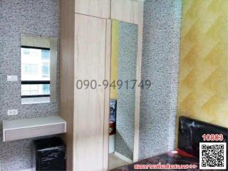 Compact bedroom interior with built-in wardrobe and granite flooring