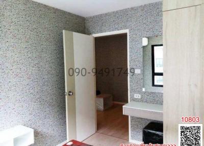 Compact bedroom with terrazzo walls and built-in counter