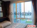 Contemporary bedroom with a view of the city and natural light