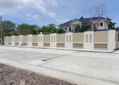 Elegant two-story house with a secure beige fence