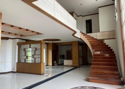 Spacious two-story home interior with wooden staircase and open floor plan