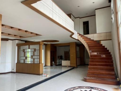 Spacious two-story home interior with wooden staircase and open floor plan