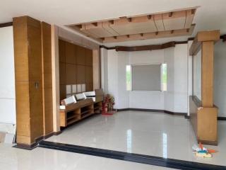 Spacious and well-lit living room with high ceiling and modern design