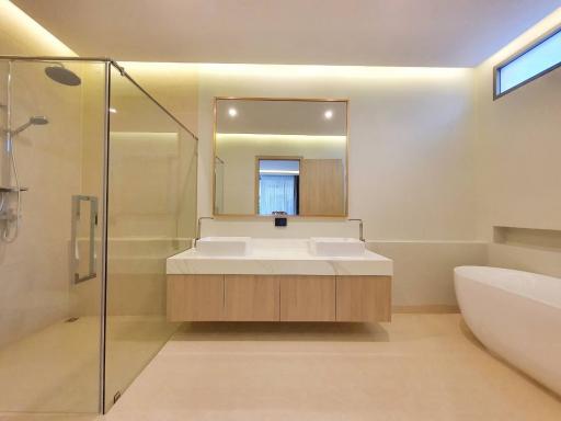 Modern bathroom with double sink and glass shower stall