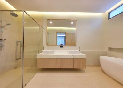 Modern bathroom with double sink and glass shower stall