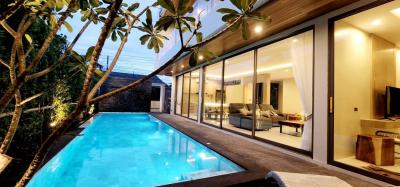 Modern house with pool and glass doors at twilight