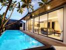 Modern house with pool and glass doors at twilight