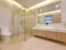 Modern bathroom with glass shower stall, large mirror, and wooden cabinetry