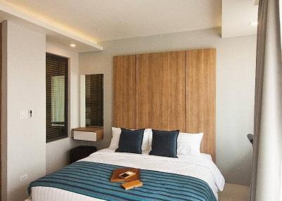 Modern bedroom with a large bed and wooden headboard