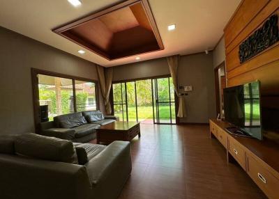 Spacious living room with garden view and modern furnishings