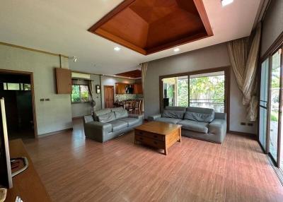Spacious living room with high ceiling and natural light