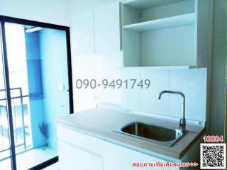 Modern kitchen with white cabinetry and stainless steel sink