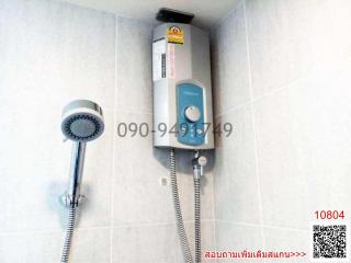 Electric shower head with heater and hand shower in a tiled bathroom
