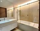 Modern bathroom with glass shower division and wooden accents