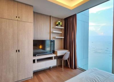 Modern bedroom with floor-to-ceiling window and sea view