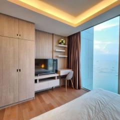 Modern bedroom with floor-to-ceiling window and sea view