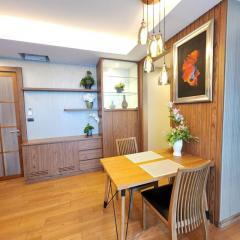 Contemporary dining area with wooden decor and elegant light fixtures