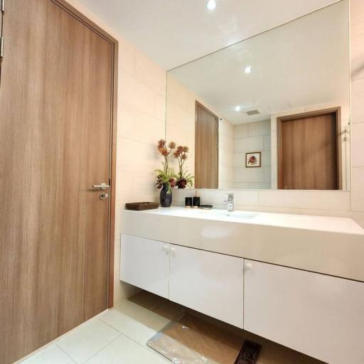 Modern bathroom with wooden features and white cabinetry