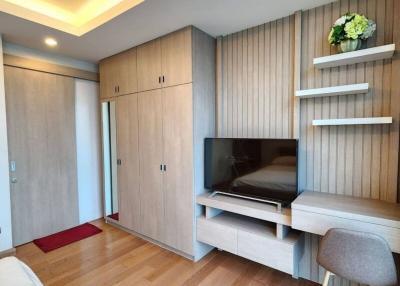 Modern bedroom with wooden floor and built-in wardrobe