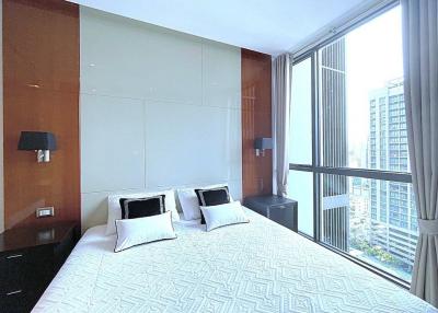 Modern bedroom with large windows and city view