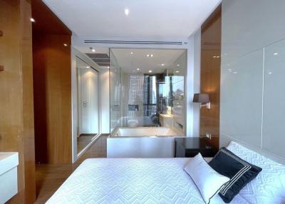 Modern bedroom with large windows and en-suite bathroom