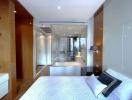 Modern bedroom with large windows and en-suite bathroom