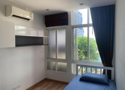 Modern bedroom with natural light and city view