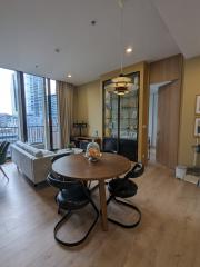 Modern living room with circular dining table and city view