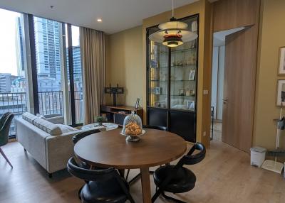 Contemporary living room with dining area and balcony access in a modern apartment