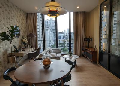 Modern living room with dining area and city view