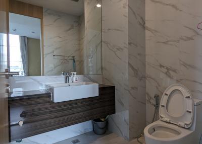 Modern bathroom interior with marble tiles and floating vanity