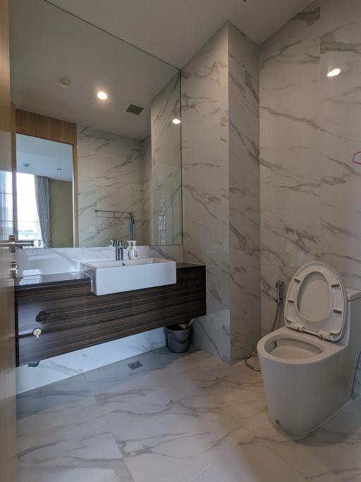 Modern bathroom interior with marble tiles and floating vanity