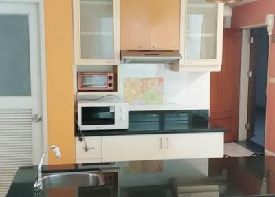 Modern kitchen interior with bright cabinets and stainless steel appliances