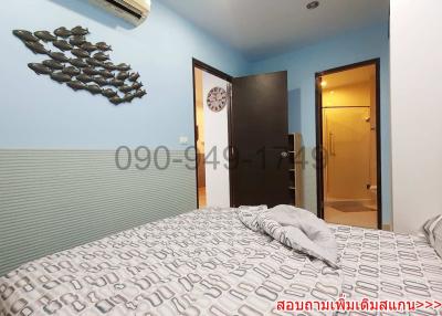 Cozy bedroom with striped headboard wall, decorative elements, and en-suite bathroom