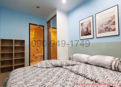 Cozy bedroom with blue walls, a large bed, and modern decor