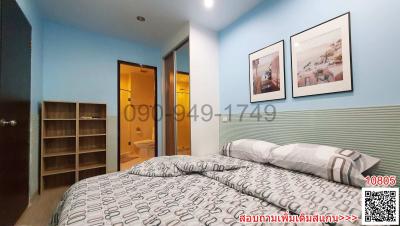 Cozy bedroom with blue walls, a large bed, and modern decor