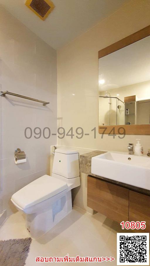 Modern bathroom interior with white fixtures and wooden cabinet