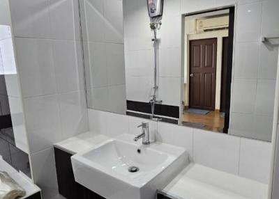 Modern bathroom with white tiles and sleek fixtures