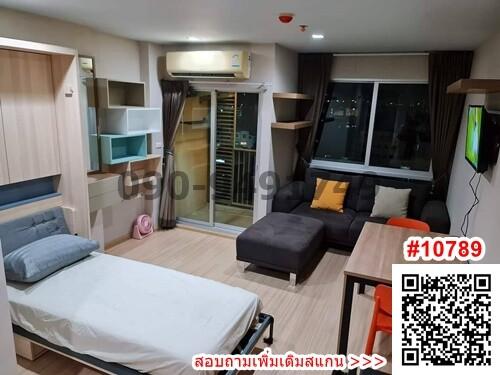 Compact bedroom with integrated living space including bed, couch, and furnishings