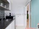 Modern kitchen interior with white cabinets and black countertop