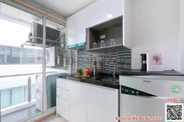 Modern kitchen with white cabinetry and stainless steel appliances