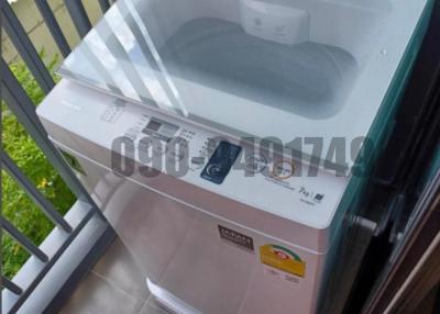 Compact washing machine in a residential balcony setting