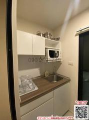 Compact modern kitchen with white cabinets and stainless steel sink