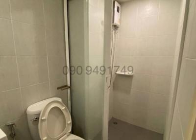 Compact modern bathroom with enclosed shower and toilet