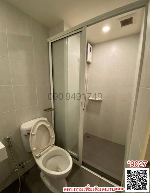 Compact modern bathroom with enclosed shower and toilet