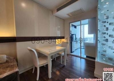 Modern dining room with natural light and balcony access