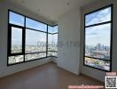 Spacious empty room with large windows and city view