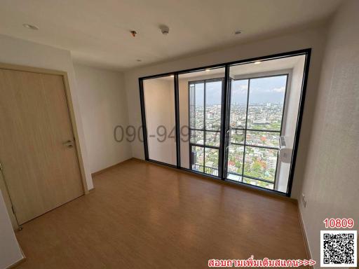 Spacious bedroom with large windows and city view