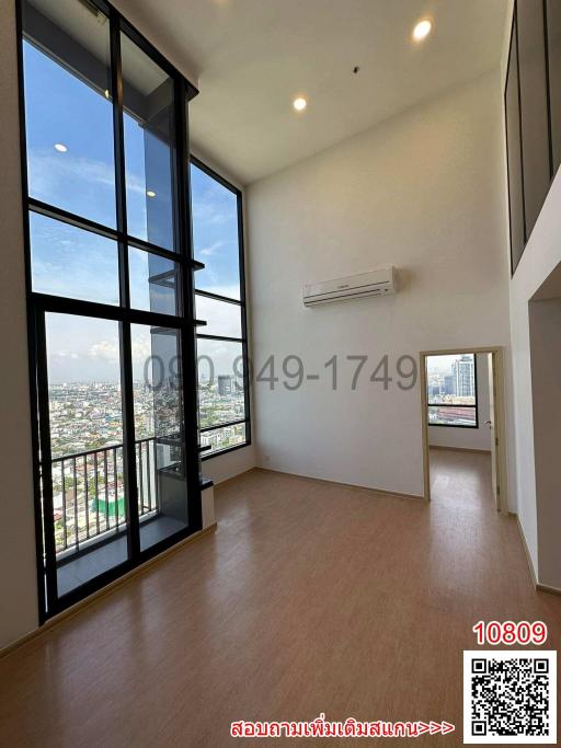 Spacious living room with large windows and city view